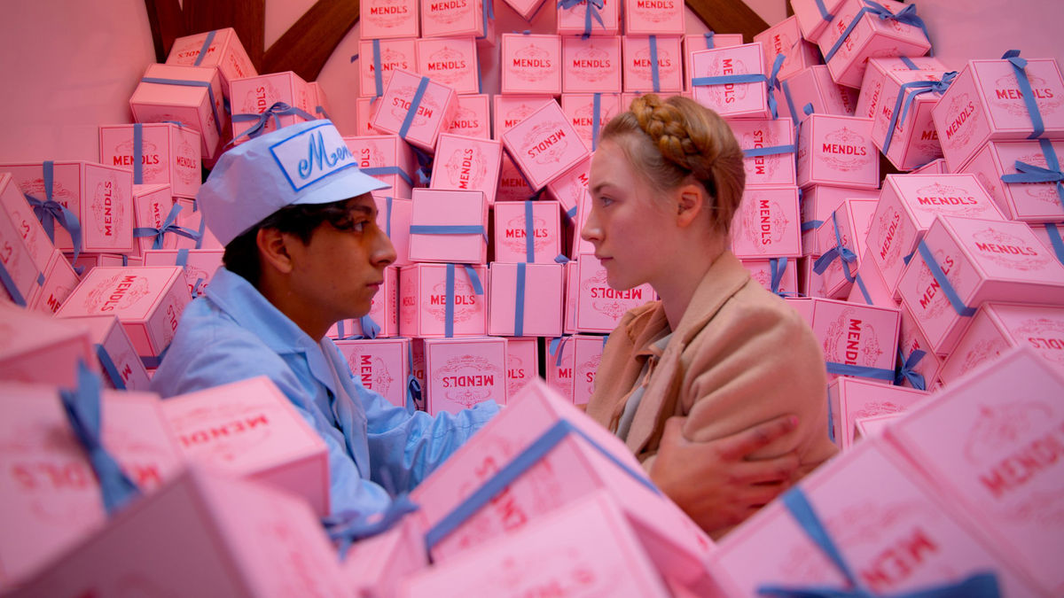 A scene from Grand Budapest Hotel, with characters framed by bright pink boxes