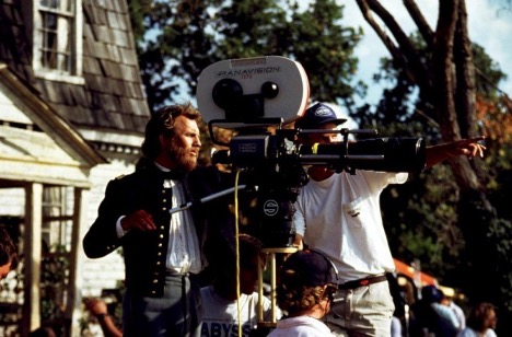 Kevin Costner holding a film camera on the set of Dances with Wolves
