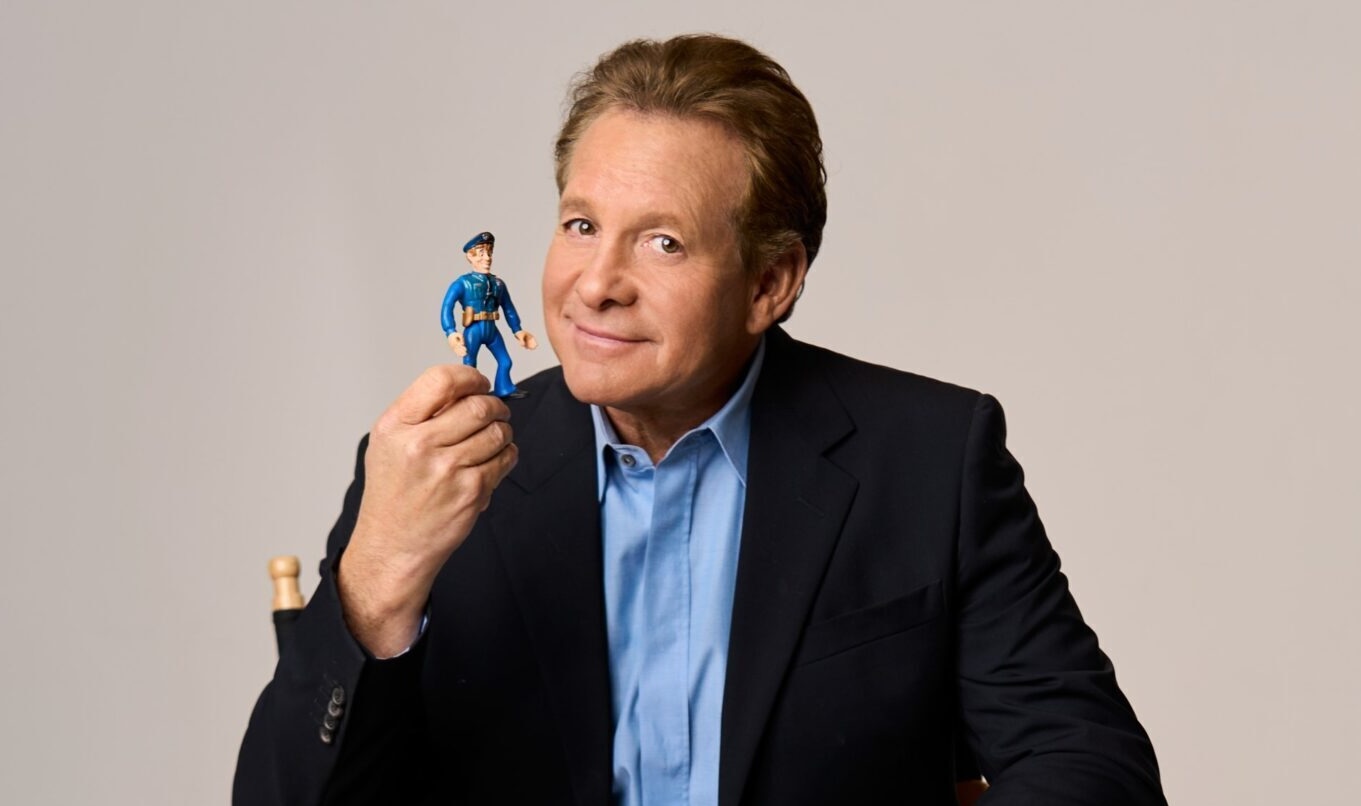Steve Guttenberg with a Police Academy action figure