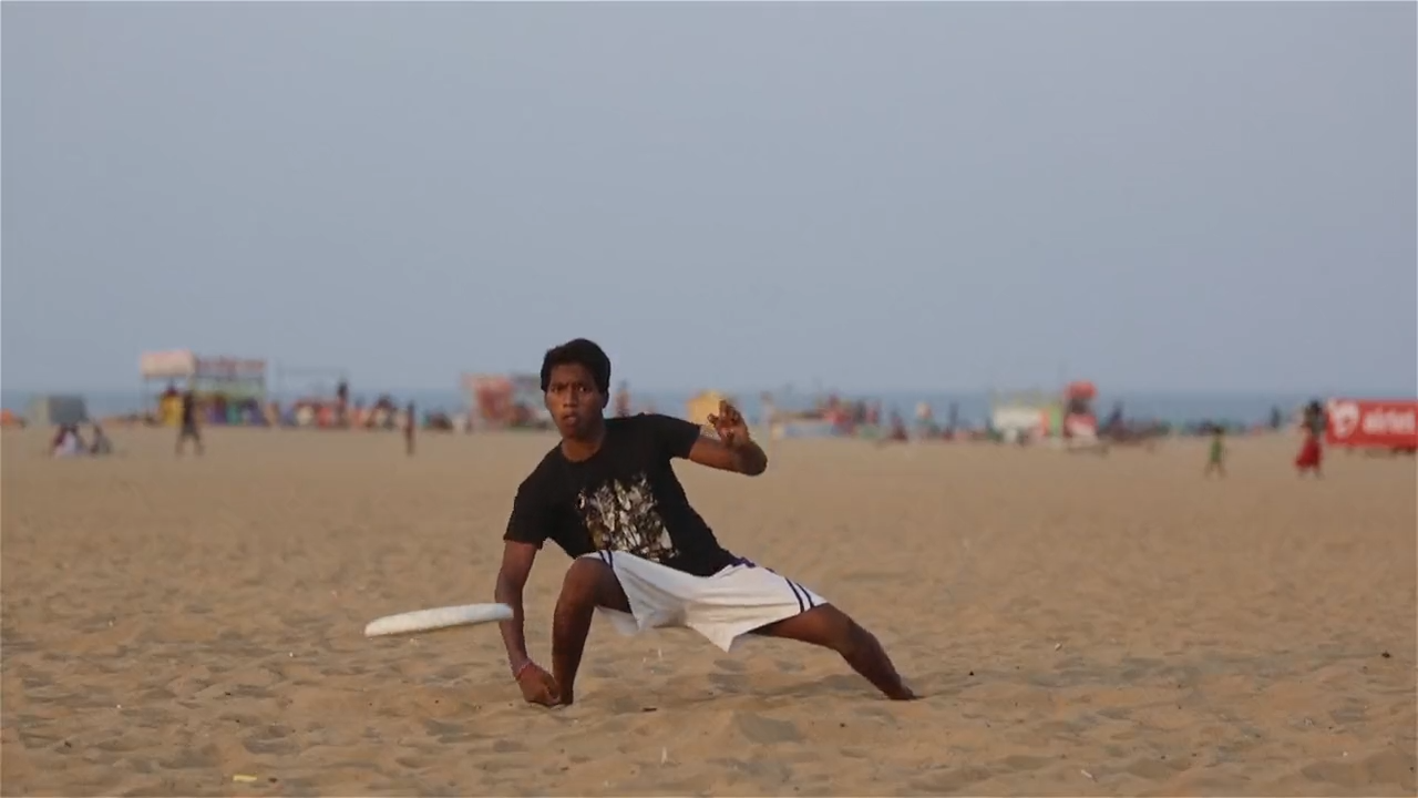 Kids playing frizbee on the beach